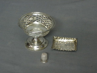 A circular pierced silver bowl raised on a circular spreading foot, Birmingham 1913 3" together with an embossed silver pin tray 2" and a thimble