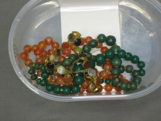 2 strings of green hardstone beads, a string of amber coloured beads and a gilt metal and hardstone necklet