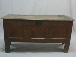 An 18th Century carved oak coffer of panelled construction with hinged lid (old blacksmith's repair to top) 50"