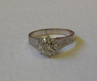 An 18ct white gold dress ring set illusion cut diamonds