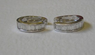 A pair of lady's 18ct white gold hoop earrings set numerous baguette cut diamonds (approx 1.06ct)