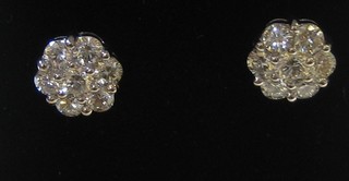 A pair of lady's 18ct white gold floral shaped ear studs set 8 diamonds (approx 1.16ct)