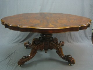 A Victorian oval figured walnut Loo table, raised on a carved column and tripod base 56"