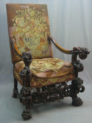 An impressive 17th Century style Italian  walnut open arm chair, the arms carved lions and heavily carved throughout