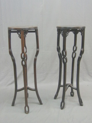 A pair of 19th/20th Century Padouk wood jardiniere stands 
