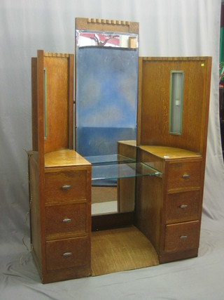A 1930's limed oak dressing table with mirror to the centre flanked by 2 arched sections fitted 6 drawers 42"