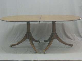 A Georgian style bleached mahogany twin pillar D end extending dining table with 1 extra leaf