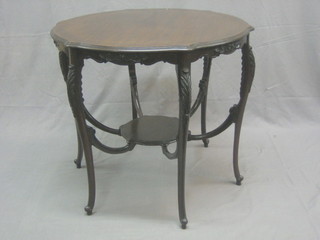 An Edwardian circular mahogany 2 tier occasional table, raised on 6 cabriole supports 32"
