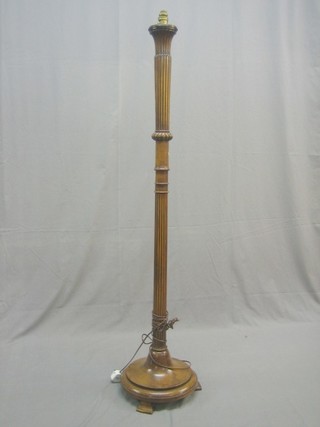 A walnut turned and reeded standard lamp