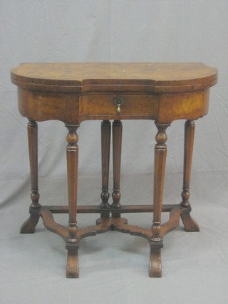 An Edwardian William & Mary style figured walnut Credence table of shaped outline, fitted a drawer, raised on turned supports with wavy stretcher by Heal & Reigate London 28"