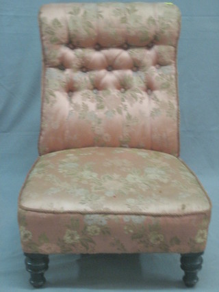 A Victorian mahogany framed nursing chair upholstered in pink buttoned back material