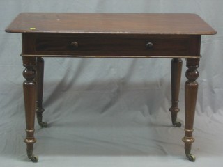 A Victorian mahogany D shaped writing table fitted a drawer, raised on turned supports, the drawer signed MAB E & Co 42"