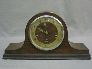 A 1930's striking mantel clock with silver dial and Arabic numerals contained in an oak Admirals hat shaped case