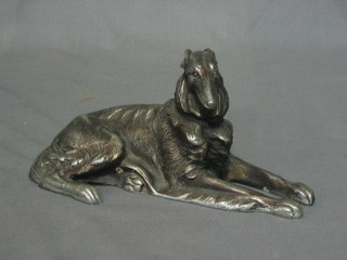 A Russian metal figure of a seated Afghan hound, the base marked Kac 7"