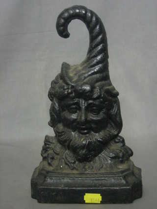 A Victorian cast iron door stop in the form of Bacchus