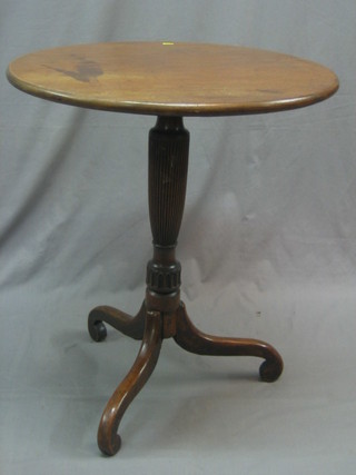 A 19th Century circular mahogany tea table, raised on a turned and fluted column with tripod base, 25"