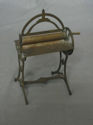 A miniature brass mangle with wooden rollers 3"