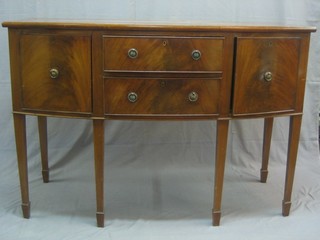 An Edwardian Georgian style mahogany bow front sideboard, fitted 2 drawers flanked by double cupboards, raised on square tapering supports ending in spade feet by Bartholomew & Fletcher 54"
