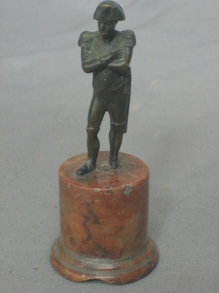 A 19th Century bronzed figure of a standing Napoleon 2 1/2" raised on a granite socle base (foot f)
