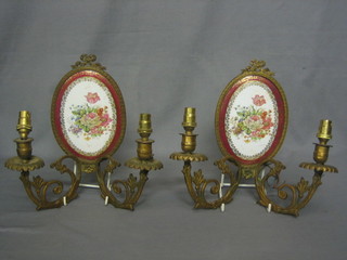 A pair of gilt metal twin wall light brackets with oval porcelain plaque and floral decoration 6"