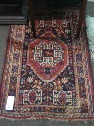 An Eastern brown ground rug with diamonds to the centre within multi-row borders 43" x 28"