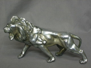 A metal figure of a walking lion 9"