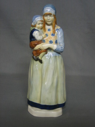 A  Dutch? porcelain figure of a standing bonnetted lady and child 13", the base with crown cypher mark 
