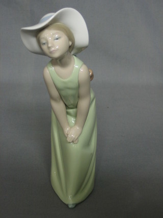 A Lladro figure of a standing bonnetted girl 9"