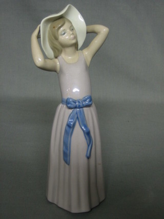 A Lladro figure of  a standing girl, the base dated 1978 10"