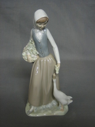A Nao figure of a standing lady with geese 9"