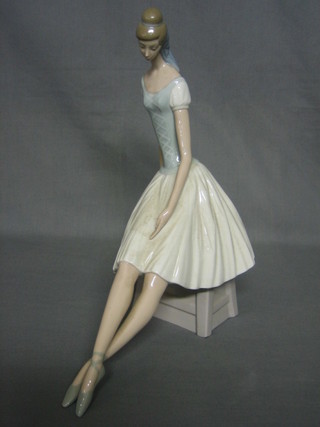 A Lladro figure of a seated ballerina 13"