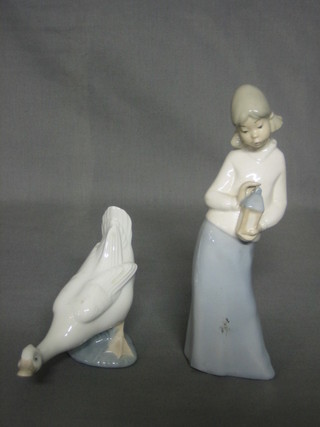 A Lladro figure of a standing goose 6" and a Lladro style figure of a lady with lantern 8"