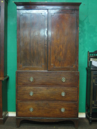 A 19th Century mahogany linen press with moulded cornice, the interior fitted 4 trays enclosed by panelled doors, the base fitted 3 long drawers raised on bracket feet 41"