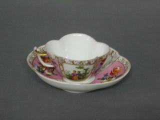 A Dresden style cup and saucer with pink panel and floral decoration