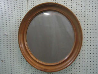 A circular plate wall mirror contained in bleached oak frame 22"