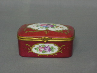 A Limoges red glazed porcelain trinket box with hinged lid and floral decoration 3 1/2"