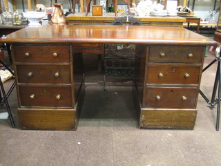 A 19th Century mahogany Ministry of Works issue kneehole pedestal desk, fitted 6 long drawers with tore handles 62"