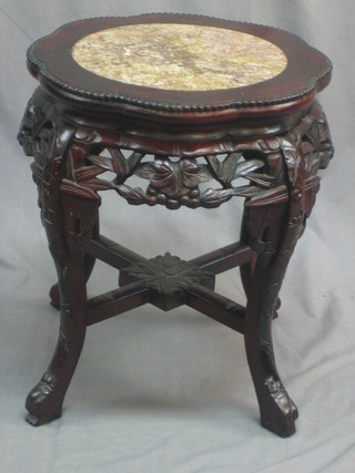A circular Eastern  pierced carved Padouk wood jardiniere stand with inset marble top, raised on cabriole supports 16"