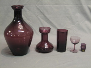 An amethyst glass club shaped vase 12", a small vase 6", a miniature vase 2", a beaker and a cocktail glass