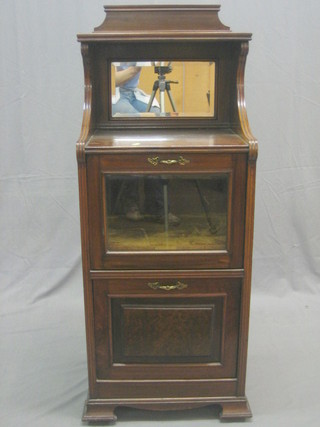 A late Victorian walnut music cabinet, the raised back fitted a mirror, the base with 2 compartments enclosed by panelled doors 18"