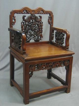 A pair of Eastern pierced Padouk wood throne chairs, raised on square tapering supports