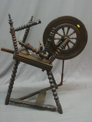 An 18th/19th Century oak spinning wheel
