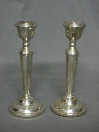 A pair of modern plain silver candlesticks with bead work decoration 7"