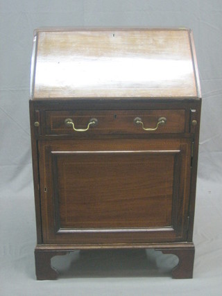 An Edwardian inlaid mahogany bureau, the fall front revealing a well fitted interior above 1 long drawer, the base fitted a cupboard, raised on bracket feet 23"