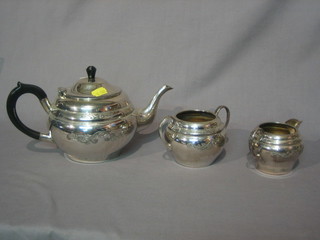 An oval engraved silver plated 3 piece tea service with teapot, twin handled sugar bowl and cream jug