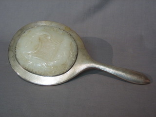 An Eastern planished silver hand mirror with carved green hardstone panel