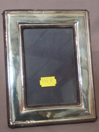 A modern plain silver easel photograph frame 5" x 3 1/2"