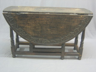An 18th Century carved oak drop flap gateleg dining table, raised on turned and block supports 47"