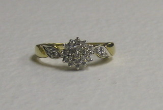 A lady's gold cluster ring set numerous diamonds