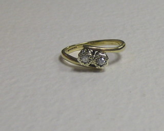 A lady's 18ct gold cross-over dress ring set 2 illusion set diamonds